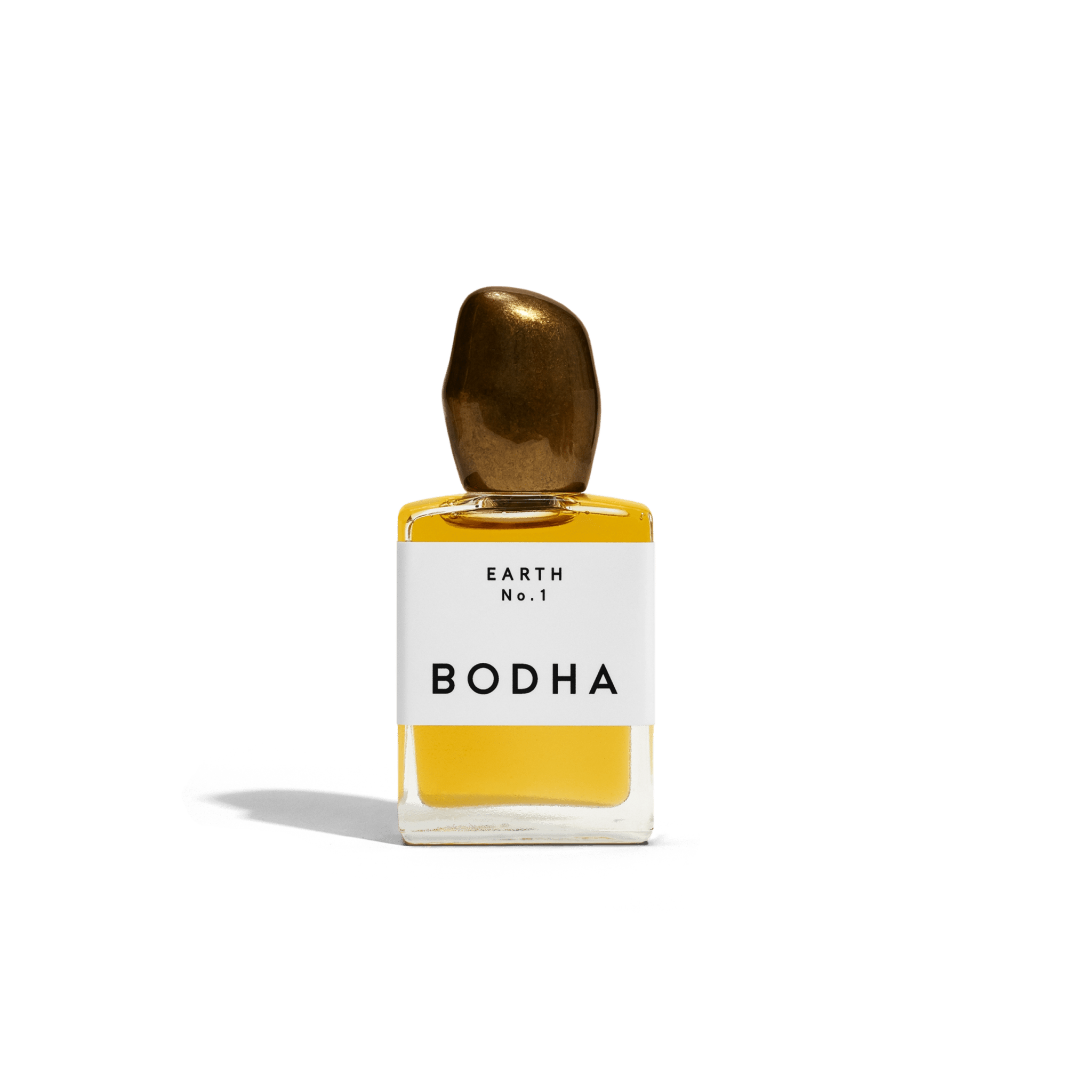 Bodha perfume bottle with gold cap and yellow liquid on white background