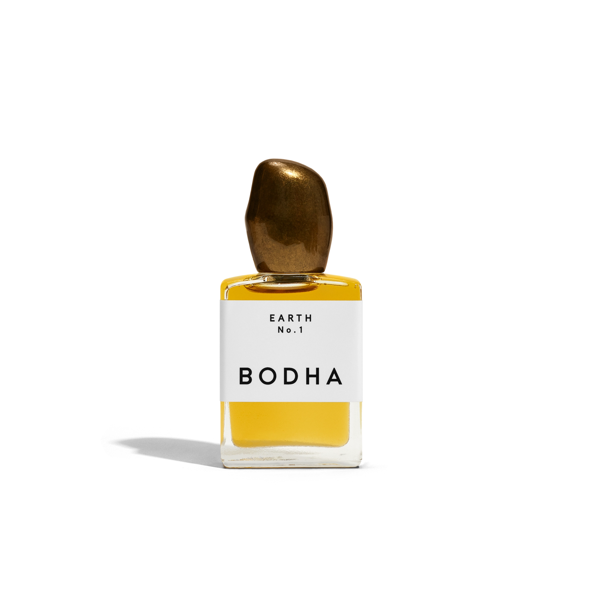 Bodha perfume bottle with gold cap and yellow liquid on white background