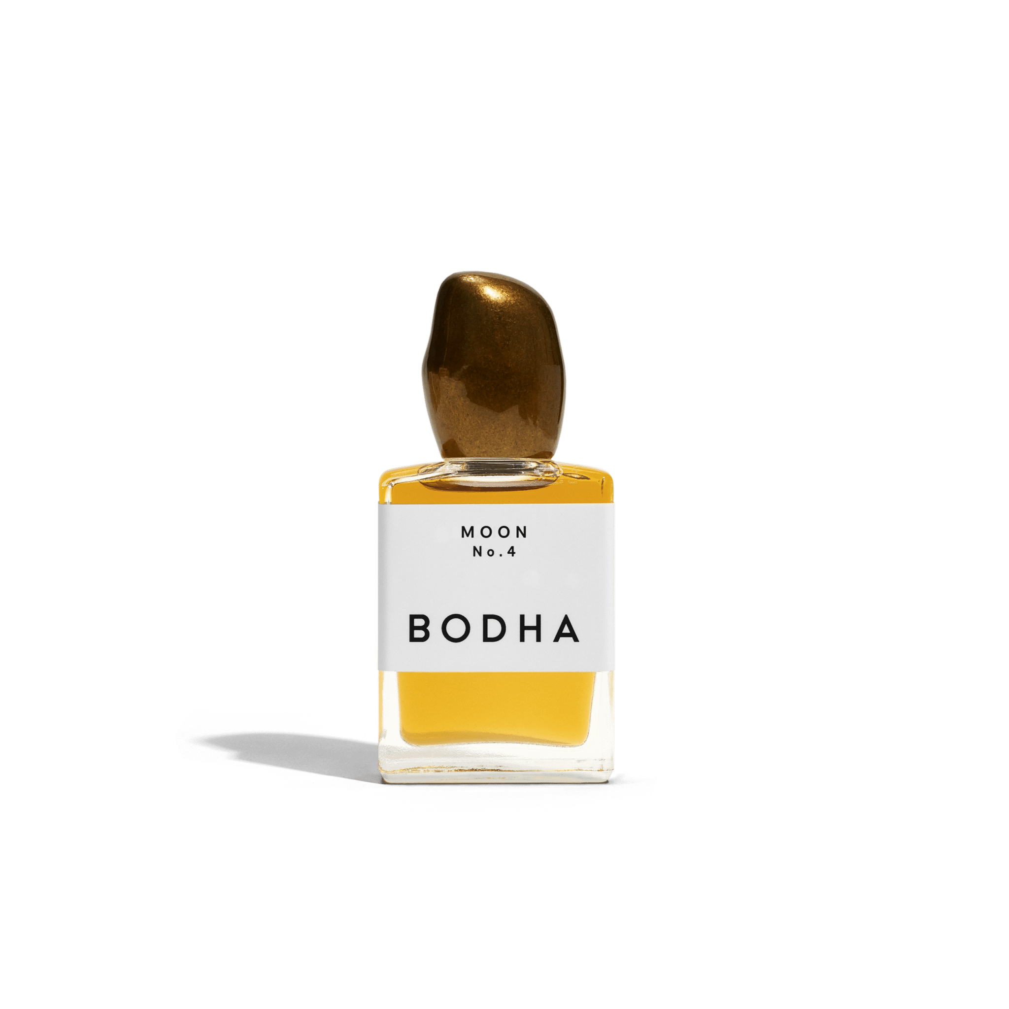 Bodha perfume bottle with gold cap and yellow liquid on white background