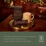 Ancient + Brave Cacao + Collagen Sachets box beside a cup of cacao, a nutrient-dense chocolatey formula with adaptogens