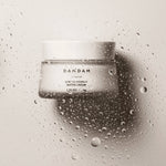 DAMDAM Ginkgo Bouncy Water Cream jar surrounded by water droplets for refreshing hydration