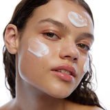 Model with DAMDAM Ginkgo Bouncy Water Cream applied to her cheeks and forehead