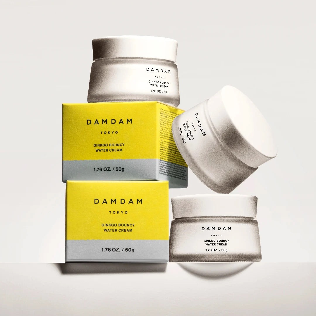 Stacked DAMDAM Ginkgo Bouncy Water Cream jars and yellow boxes
