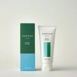 DAMDAM Skin Mud Pure Mask tube beside its green and blue box