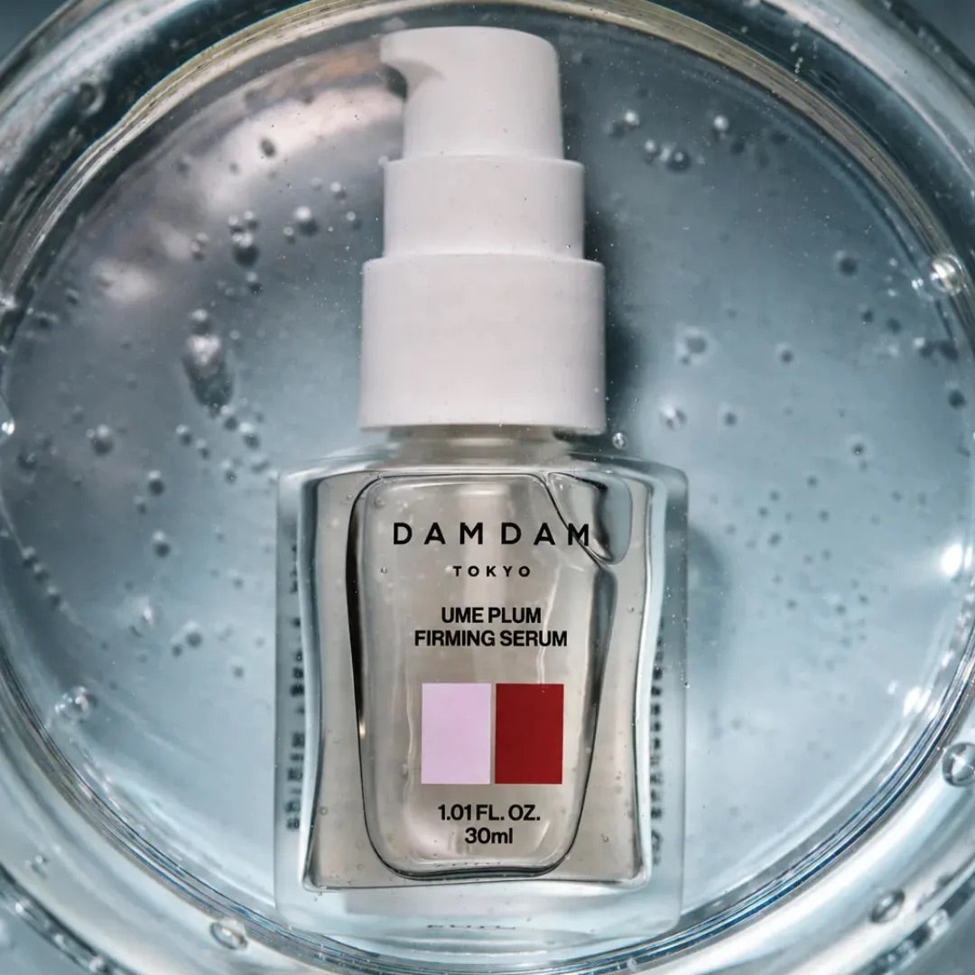 DAMDAM Ume Plum Firming Serum bottle in water with bubbles