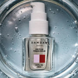 DAMDAM Ume Plum Firming Serum bottle in water with bubbles