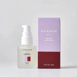 DAMDAM Ume Plum Firming Serum bottle beside its purple and burgundy box