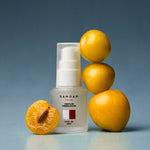 DAMDAM Ume Plum Firming Serum bottle with fresh Japanese ume plums