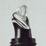 Clear buttery texture of Herbar The Lip Butter Black Sesame swirling from the applicator tip