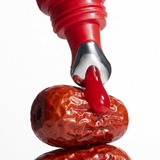 Herbar The Lip Butter Jujube tube on stacked dried jujubes, the fruit that inspired its flavour