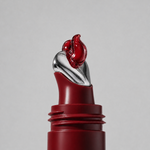 Red buttery texture of Herbar The Lip Butter Jujube swirling from the applicator tip