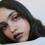 Model wearing Manasi 7 Eye and Lip Definer Nocturne on the lips for a defined bronze brown look