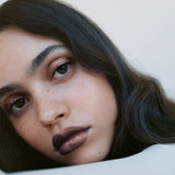 Model wearing Manasi 7 Eye and Lip Definer Nocturne on the lips for a defined bronze brown look