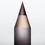 Sharpened tip of Manasi 7 Eye and Lip Definer Nocturne against a soft dark background