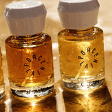Porcelain natural eau de parfum bottles including Gerain glowing in warm sunlight