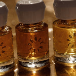 Porcelain natural eau de parfum bottles including Jasmada glowing in warm sunlight