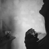 Black and white silhouette of a person spraying Porcelain No 2 Myristica natural eau de parfum onto the neck