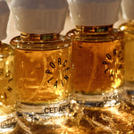 Porcelain natural eau de parfum bottles including No 3 Cedarté glowing in warm sunlight