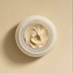 Open jar of RAESO Cocoon Ceramide Cream mini showing its whipped, cushiony texture