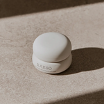RAESO Lunar Veil Chrono-Active Sleep Mask 5 ml mini jar in soft sunlight