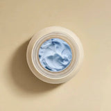 Open jar of RAESO Lunar Veil Chrono-Active Sleep Mask mini showing its soft, light blue cream texture