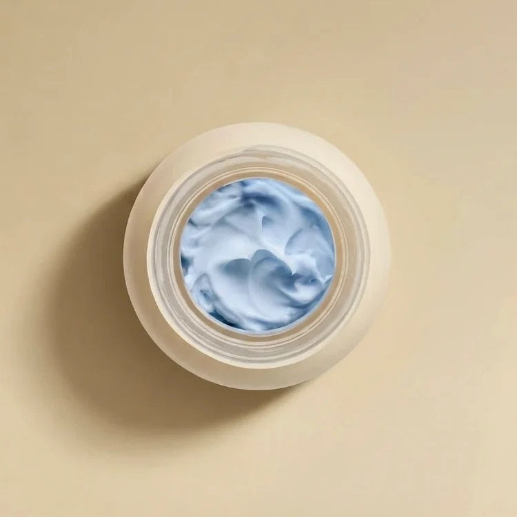 Open jar of RAESO Lunar Veil Chrono-Active Sleep Mask mini showing its soft, light blue cream texture