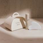 RAESO Sculpt & Lift Mini Ritual Set gift box, cleanser mini and gua sha in soft sunlight