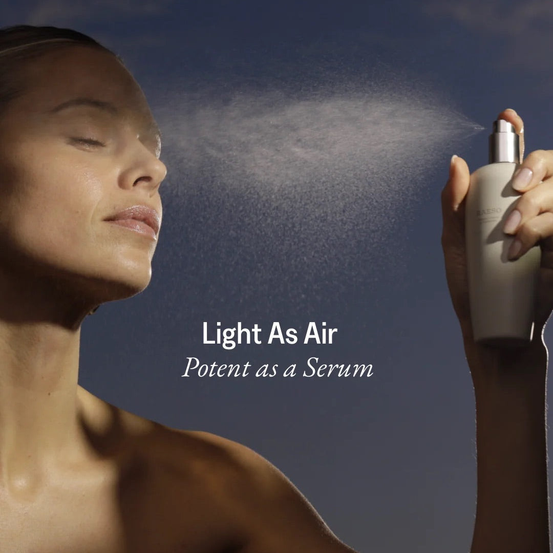 Model misting her face with RAESO Tranquillity Water Activating Mist for lightweight, dewy hydration