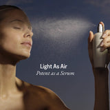 Model misting her face with RAESO Tranquillity Water Activating Mist for lightweight, dewy hydration